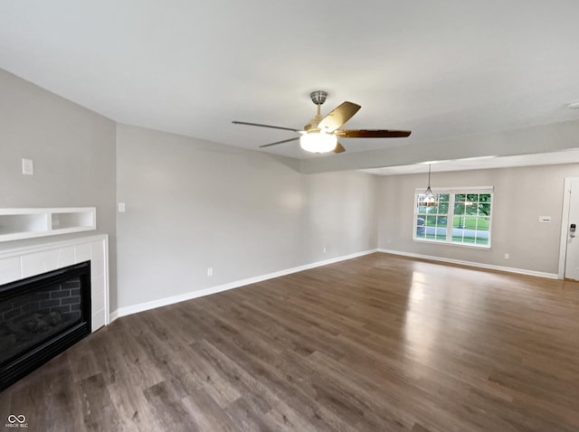 770 Tulip Ln, Greenwood, IN 46143 - unfurnished living room featuring a ceiling fan, dark wood-type flooring, and a tiled fireplace