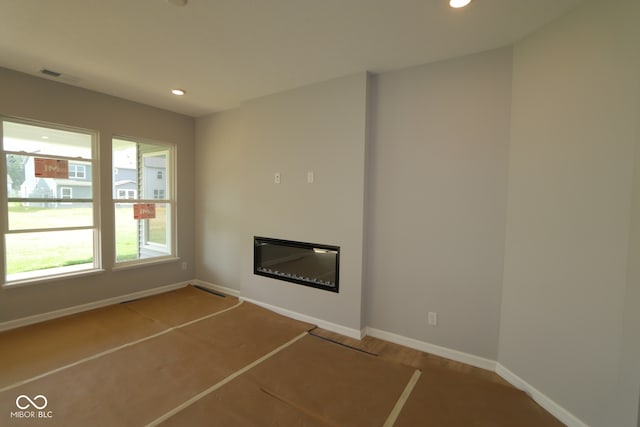 10602 Maidenhair Dr, Indianapolis, IN 46239 - unfurnished living room with a glass covered fireplace and recessed lighting