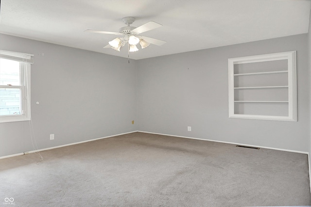 3322 N Riley Ave N, Indianapolis, IN 46218 - empty room featuring carpet floors, ceiling fan, and built in features