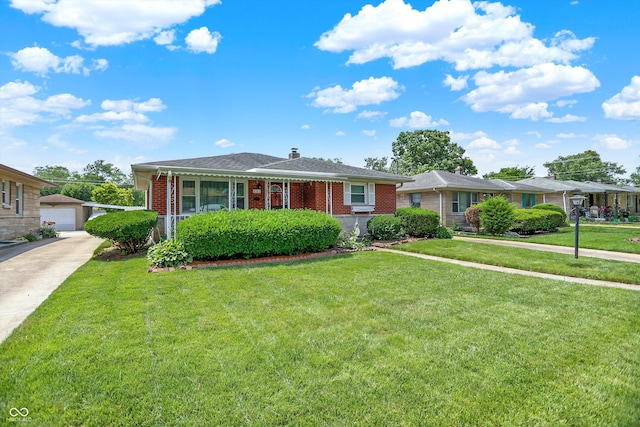 3322 N Riley Ave N, Indianapolis, IN 46218 - view of front of house featuring brick siding, an outbuilding, and a front yard