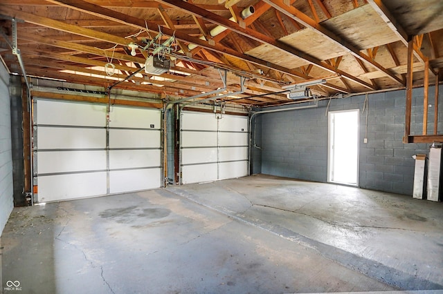 3322 N Riley Ave N, Indianapolis, IN 46218 - garage featuring a garage door opener and concrete block wall
