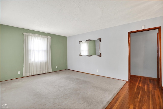 3322 N Riley Ave N, Indianapolis, IN 46218 - empty room with a textured ceiling and wood-type flooring