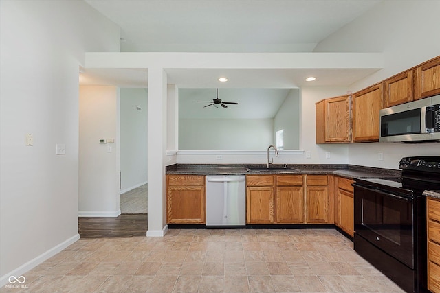 12121 Driftstone Dr, Fishers, IN 46037 - kitchen featuring stainless steel appliances, ceiling fan, dark countertops, brown cabinetry, and recessed lighting