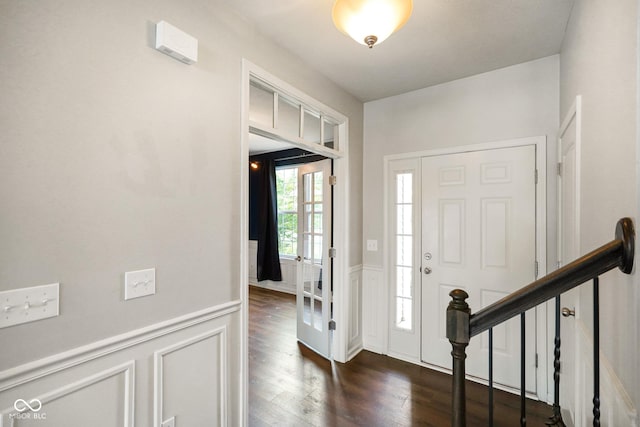 6670 Shooting Star Dr, Whitestown, IN 46075 - foyer with dark wood-style flooring, a wainscoted wall, a decorative wall, and stairway