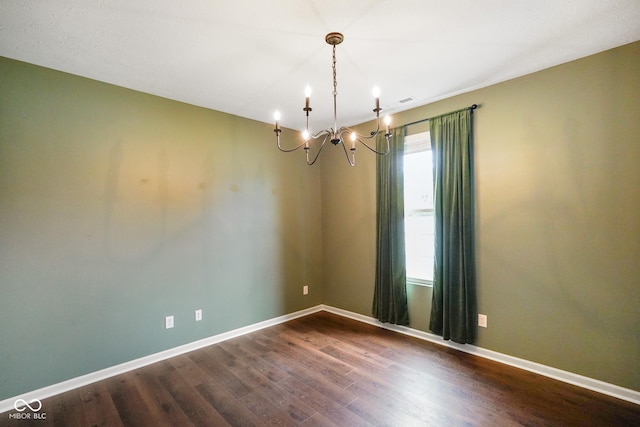6670 Shooting Star Dr, Whitestown, IN 46075 - unfurnished room featuring a chandelier and dark wood finished floors