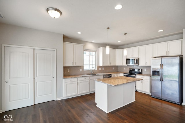 6670 Shooting Star Dr, Whitestown, IN 46075 - kitchen with appliances with stainless steel finishes, backsplash, dark wood-type flooring, light stone counters, and recessed lighting