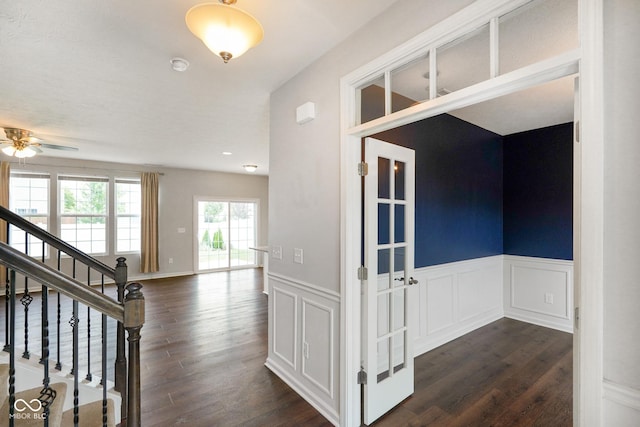 6670 Shooting Star Dr, Whitestown, IN 46075 - corridor featuring dark wood-style flooring, a wainscoted wall, a decorative wall, and stairway