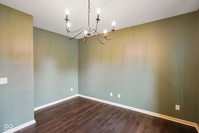 6670 Shooting Star Dr, Whitestown, IN 46075 - empty room featuring a chandelier and dark wood finished floors