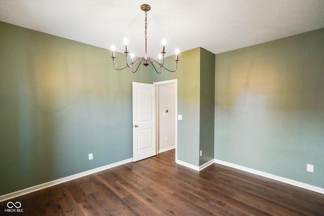 6670 Shooting Star Dr, Whitestown, IN 46075 - empty room featuring dark wood-style floors and a chandelier