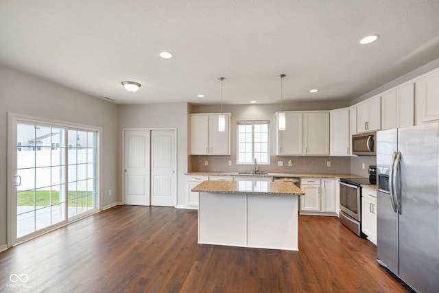 6670 Shooting Star Dr, Whitestown, IN 46075 - kitchen featuring appliances with stainless steel finishes, decorative backsplash, white cabinetry, recessed lighting, and dark wood finished floors