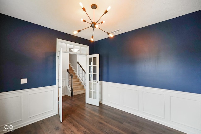 6670 Shooting Star Dr, Whitestown, IN 46075 - unfurnished dining area featuring a chandelier, french doors, wainscoting, and dark wood finished floors