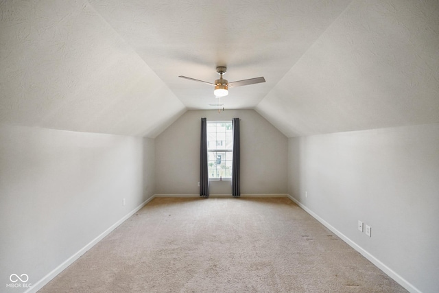 6670 Shooting Star Dr, Whitestown, IN 46075 - bonus room with ceiling fan, light colored carpet, vaulted ceiling, and a textured ceiling