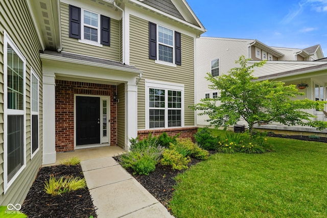 6670 Shooting Star Dr, Whitestown, IN 46075 - property entrance with brick siding and a lawn