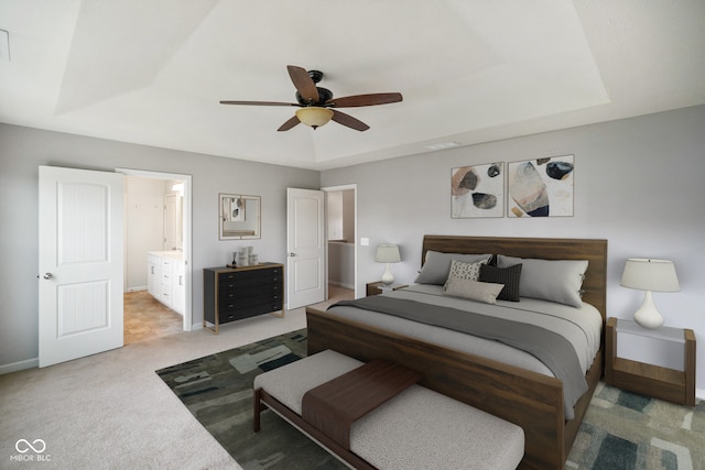 6670 Shooting Star Dr, Whitestown, IN 46075 - bedroom with a tray ceiling, light colored carpet, a ceiling fan, and connected bathroom