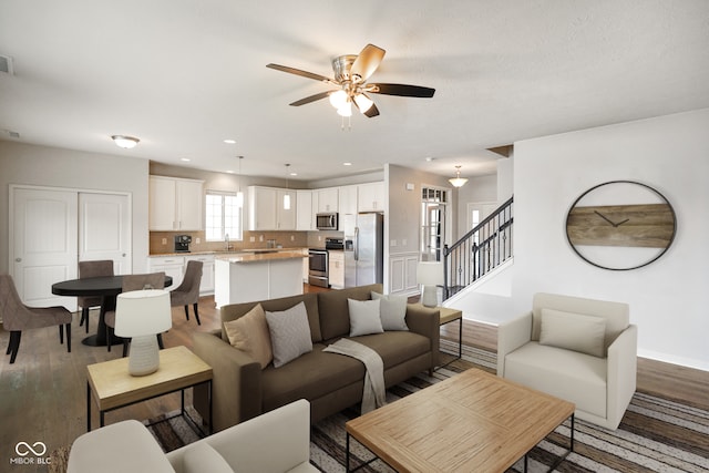 6670 Shooting Star Dr, Whitestown, IN 46075 - living area featuring a ceiling fan, stairway, wood finished floors, and recessed lighting