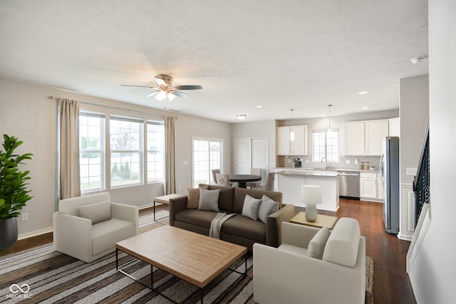 6670 Shooting Star Dr, Whitestown, IN 46075 - living room featuring dark wood-style flooring, a ceiling fan, a textured ceiling, and recessed lighting