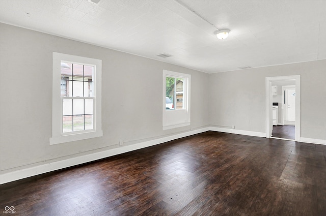 1418 W 5th St, Anderson, IN 46016 - empty room featuring plenty of natural light and dark wood-type flooring