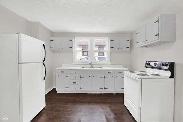 1418 W 5th St, Anderson, IN 46016 - kitchen with white appliances, dark wood-style flooring, light countertops, and white cabinets