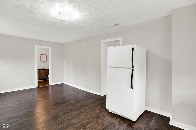 1418 W 5th St, Anderson, IN 46016 - unfurnished room with dark wood-style flooring and a textured ceiling