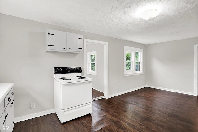 1418 W 5th St, Anderson, IN 46016 - kitchen with white range with electric stovetop, dark wood-style floors, white cabinets, light countertops, and a textured ceiling