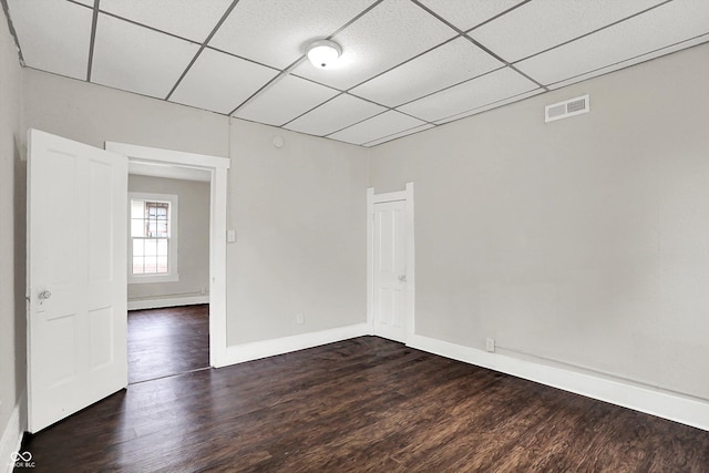 1418 W 5th St, Anderson, IN 46016 - empty room with a drop ceiling and dark wood-style floors