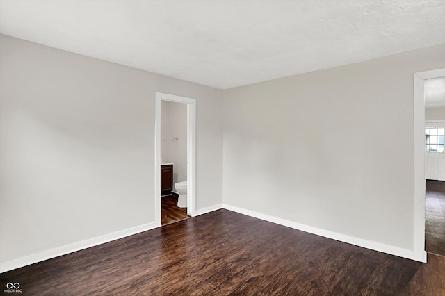 1418 W 5th St, Anderson, IN 46016 - unfurnished room featuring dark wood-type flooring and baseboards