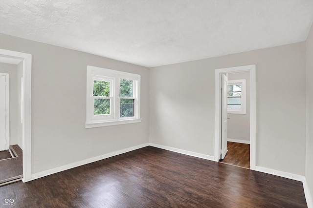 1418 W 5th St, Anderson, IN 46016 - spare room featuring plenty of natural light and dark wood-type flooring