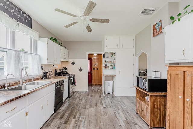 216 N Clinton St, Boswell, IN 47921 - kitchen with black appliances, light wood finished floors, ceiling fan, and white cabinetry