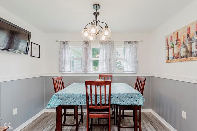 216 N Clinton St, Boswell, IN 47921 - dining room featuring wood finished floors, a chandelier, wainscoting, and a decorative wall