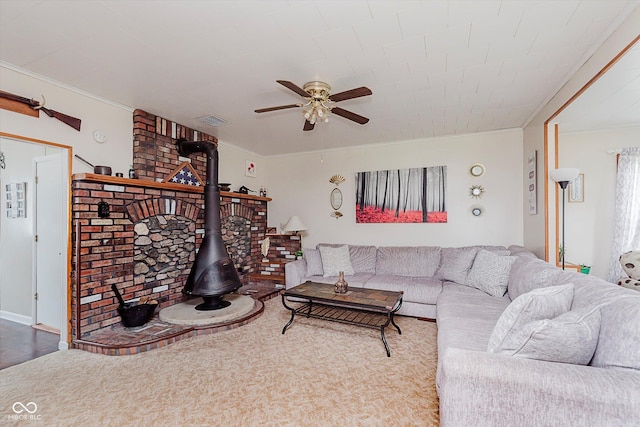 216 N Clinton St, Boswell, IN 47921 - living area featuring a wood stove, ceiling fan, and ornamental molding