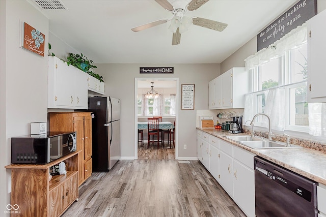 216 N Clinton St, Boswell, IN 47921 - kitchen featuring dishwashing machine, freestanding refrigerator, black microwave, light wood-style flooring, and white cabinetry