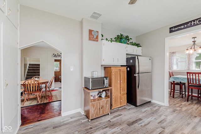 216 N Clinton St, Boswell, IN 47921 - kitchen featuring freestanding refrigerator, light wood-type flooring, and plenty of natural light