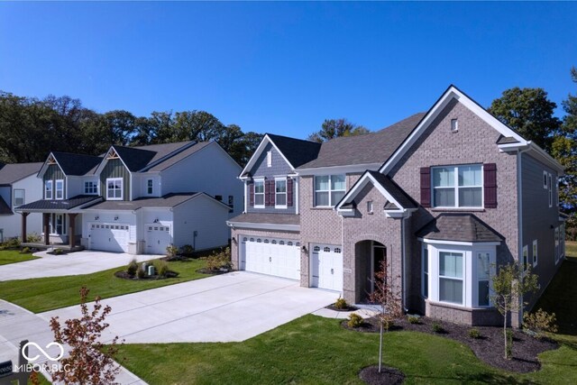 10424 Oak Bend Blvd, Indianapolis, IN 46239 - traditional-style home featuring a garage, concrete driveway, a front yard, and brick siding
