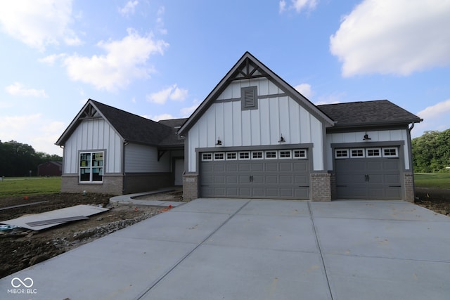 10424 Oak Bend Blvd, Indianapolis, IN 46239 - view of front of home with board and batten siding, brick siding, a garage, and driveway
