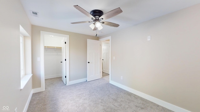 1809 S H St, Elwood, IN 46036 - unfurnished bedroom featuring carpet flooring, a walk in closet, a ceiling fan, and a closet
