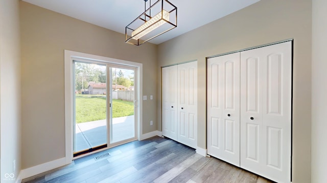 1809 S H St, Elwood, IN 46036 - doorway to outside featuring light wood finished floors and baseboards