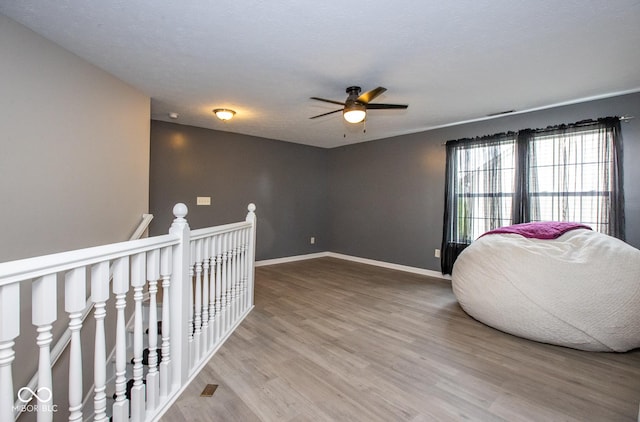 6532 Amherst Way, Zionsville, IN 46077 - sitting room with an upstairs landing, wood finished floors, and ceiling fan