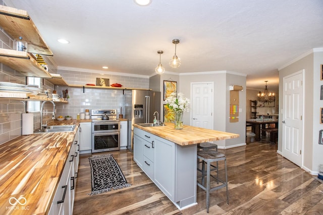 6532 Amherst Way, Zionsville, IN 46077 - kitchen featuring wood counters, open shelves, appliances with stainless steel finishes, backsplash, and ornamental molding