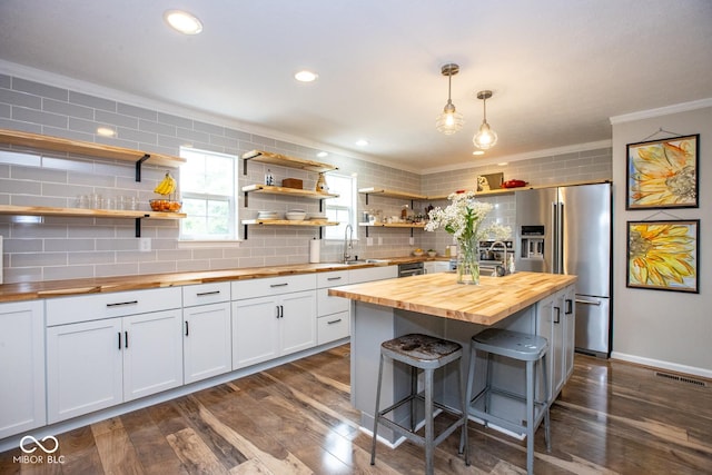 6532 Amherst Way, Zionsville, IN 46077 - kitchen featuring butcher block countertops, ornamental molding, backsplash, open shelves, and high quality fridge