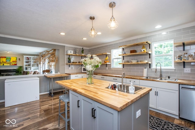 6532 Amherst Way, Zionsville, IN 46077 - kitchen featuring butcher block counters, dishwasher, open shelves, tasteful backsplash, and ornamental molding