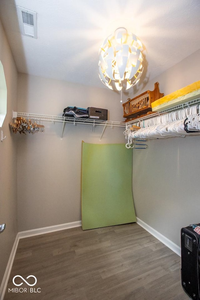 6532 Amherst Way, Zionsville, IN 46077 - walk in closet featuring wood finished floors and a chandelier
