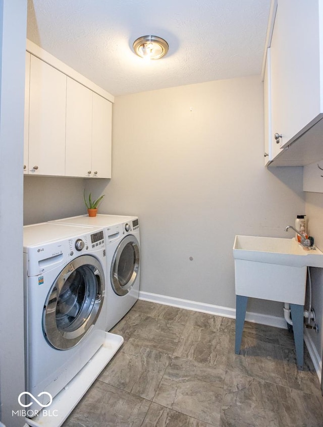 6532 Amherst Way, Zionsville, IN 46077 - laundry area with cabinet space, washing machine and clothes dryer, and a textured ceiling