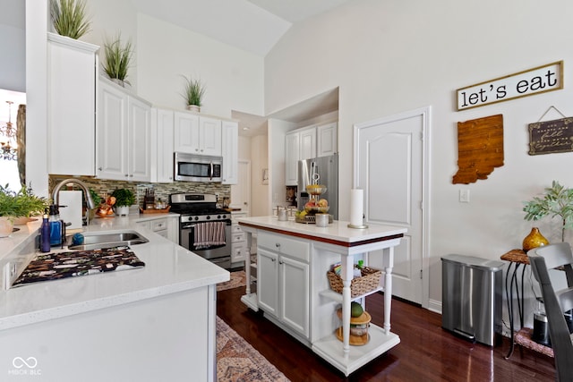 15098 Newburyport Dr, Fortville, IN 46040 - kitchen featuring stainless steel appliances, backsplash, white cabinetry, and high vaulted ceiling