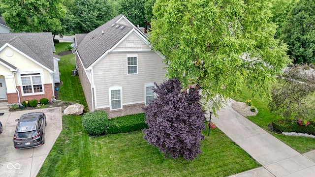 15098 Newburyport Dr, Fortville, IN 46040 - view of side of property with brick siding, a lawn, and driveway
