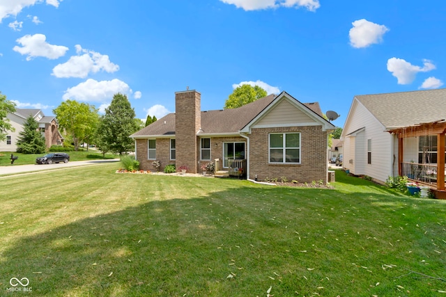 15098 Newburyport Dr, Fortville, IN 46040 - view of front of house featuring brick siding, a front lawn, and a chimney