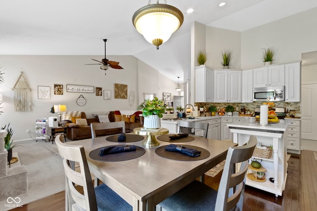 15098 Newburyport Dr, Fortville, IN 46040 - dining area featuring ceiling fan, high vaulted ceiling, and dark wood-style flooring