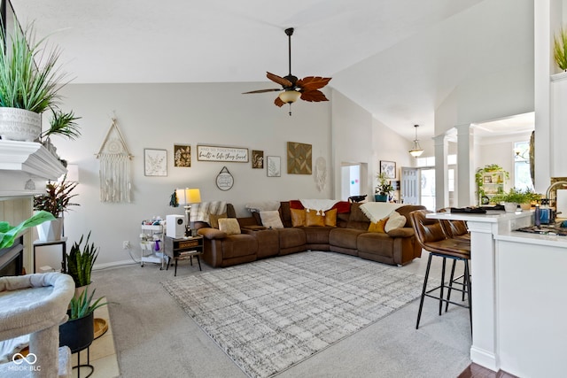 15098 Newburyport Dr, Fortville, IN 46040 - living area featuring carpet flooring, ceiling fan, high vaulted ceiling, and decorative columns