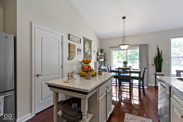 15098 Newburyport Dr, Fortville, IN 46040 - kitchen with stainless steel appliances, light countertops, dark wood-type flooring, decorative light fixtures, and lofted ceiling