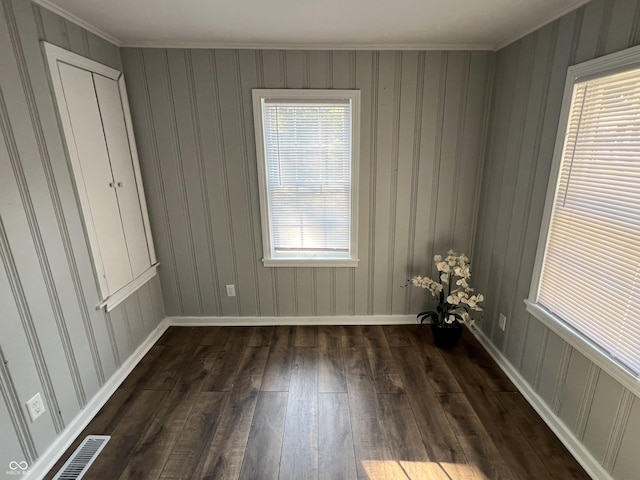 937 N Routiers Ave, Indianapolis, IN 46219 - unfurnished bedroom with dark wood-style floors, multiple windows, and ornamental molding