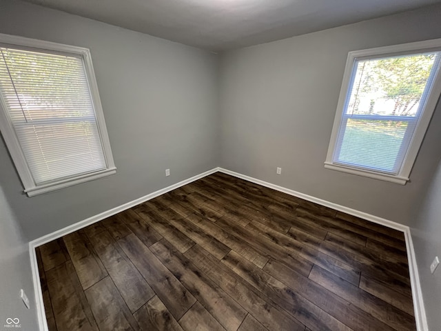 937 N Routiers Ave, Indianapolis, IN 46219 - spare room featuring dark wood-type flooring and baseboards